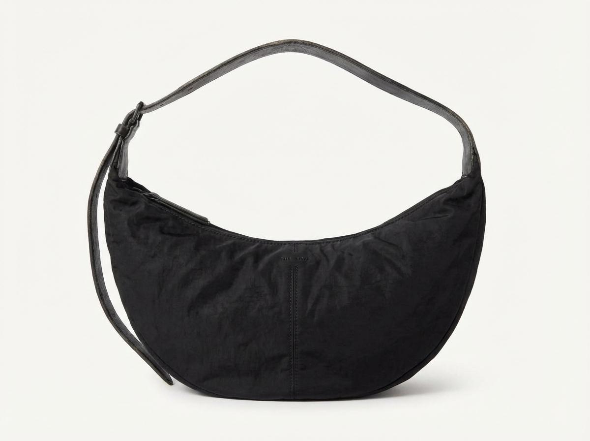 A single The Row Slouchy Banana shoulder bag in black nylon, White background, Photorealistic high resolution, detailed styling, luxury feel, No grid, no collage, no multiple items, strictly only one single object.