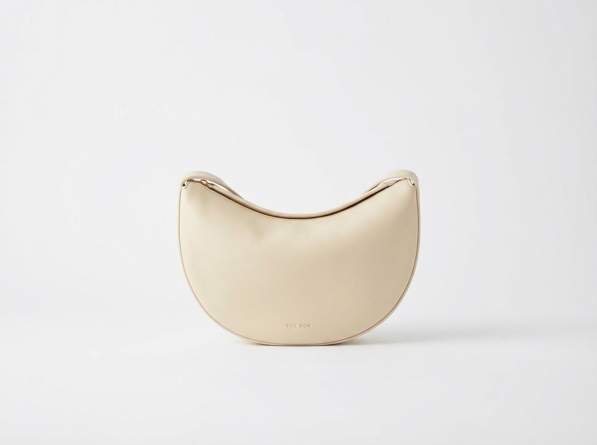 A single The Row Half Moon bag in ivory smooth leather, White background, Photorealistic high resolution, detailed styling, luxury feel, No grid, no collage, no multiple items, strictly only one single object.